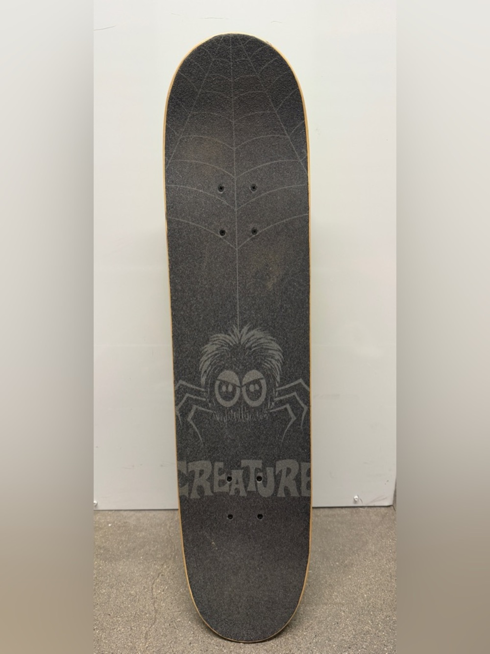 Creature Skateboards Spider skateboard featuring a custom spider and web design